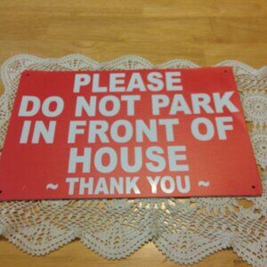 Metal sign, don't park in front of the house